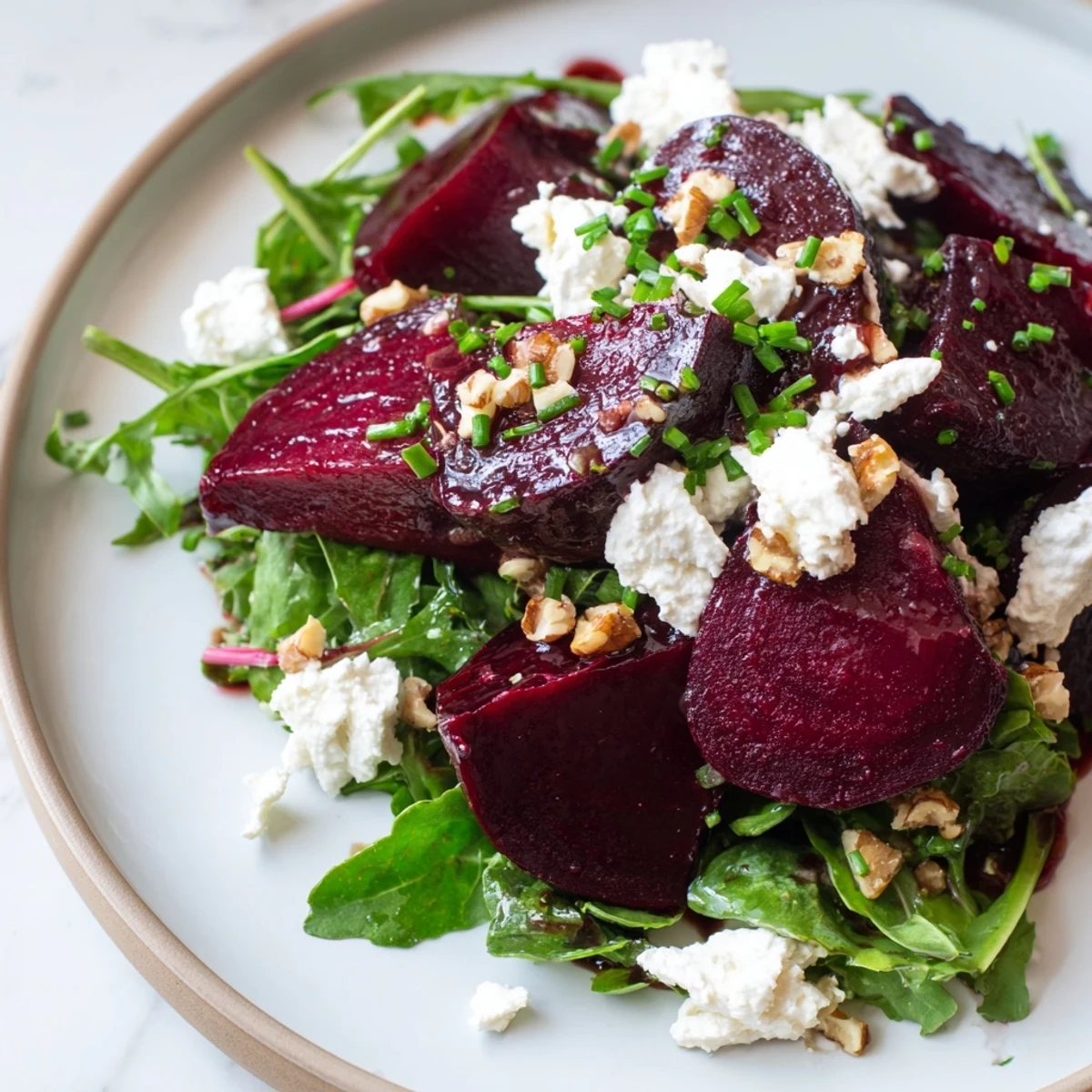 A close-up of a colorful roasted beet salad, showcasing the earthy beets and crumbled goat cheese.