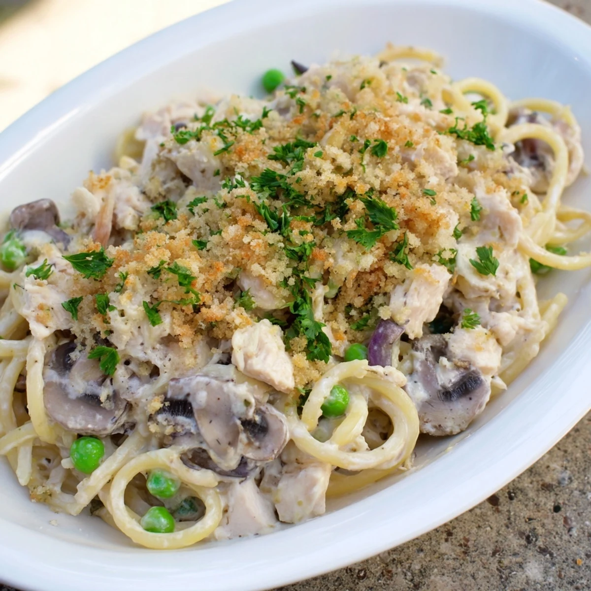 Perfectly baked Turkey Tetrazzini boasts a crispy breadcrumb topping, showcasing a satisfying texture.