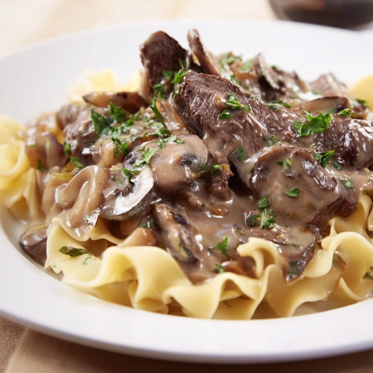 Close-up of Beef Stroganoff with rich mushroom gravy coating fork-tender beef and noodles, perfect for a cozy weeknight meal.