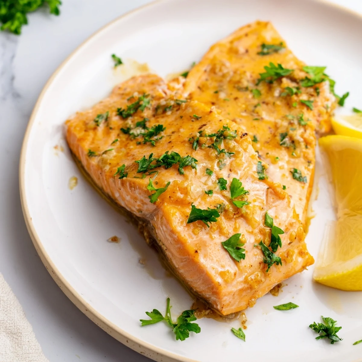 Close-up of Baked Salmon with Honey Mustard Glaze, showing a sticky, tangy coating and herbs over perfectly cooked fish.