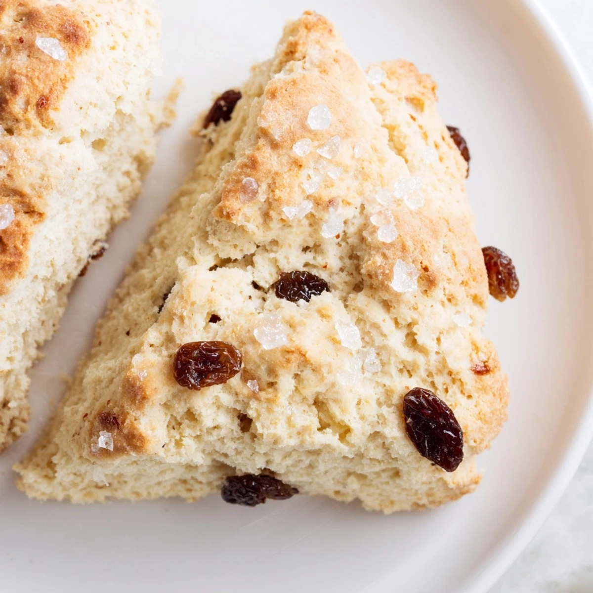 Freshly baked Irish Soda Bread Scones cut open to reveal a tender, crumbly interior dotted with sweet raisins.