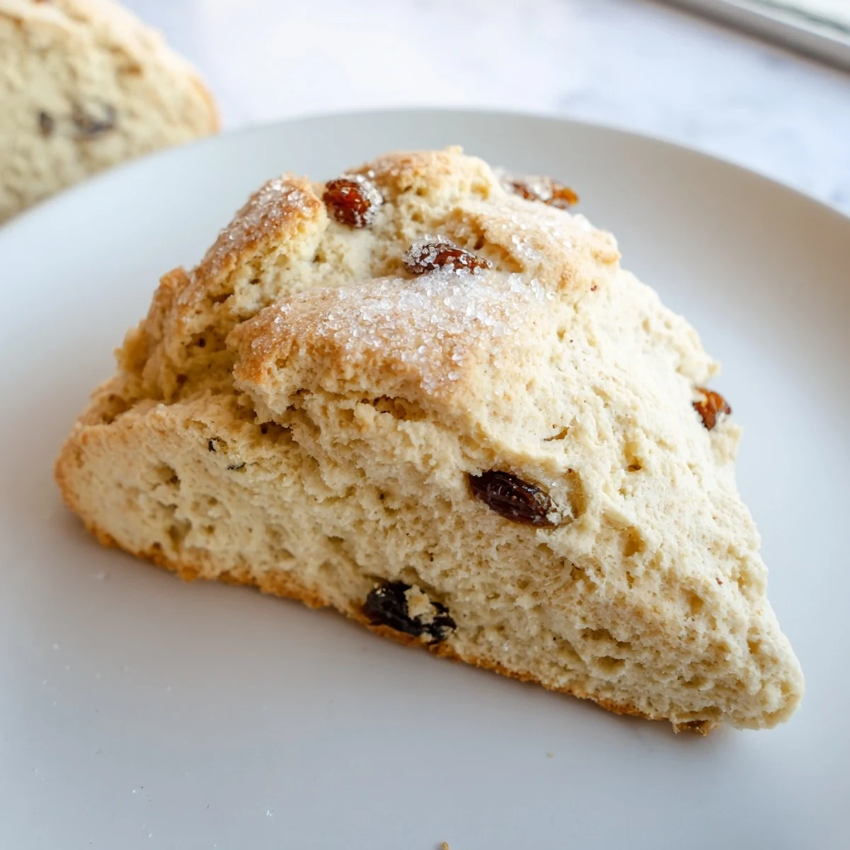 Rustic Irish Soda Bread Scones brushed with buttermilk and sprinkled with coarse sugar on a parchment-lined baking sheet.