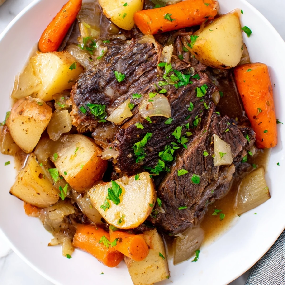 Hearty Slow Cooker Beef Pot Roast with Root Veggies plated with fresh parsley garnish for a comforting family dinner.