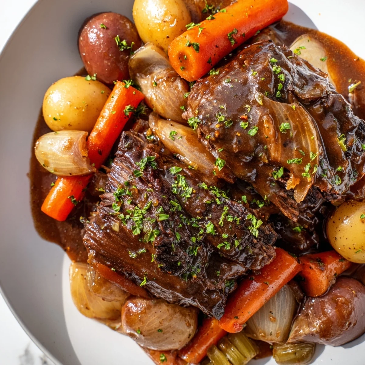 A fork tenderly lifts shredded Slow Cooker Beef Pot Roast with Root Veggies, revealing steam rising from carrots and parsnips beside a pool of savory juices.