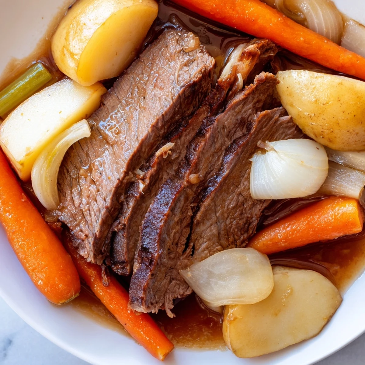 A tender slice of Slow Cooker Beef Pot Roast with Root Vegetables on a plate near a red wine glass.