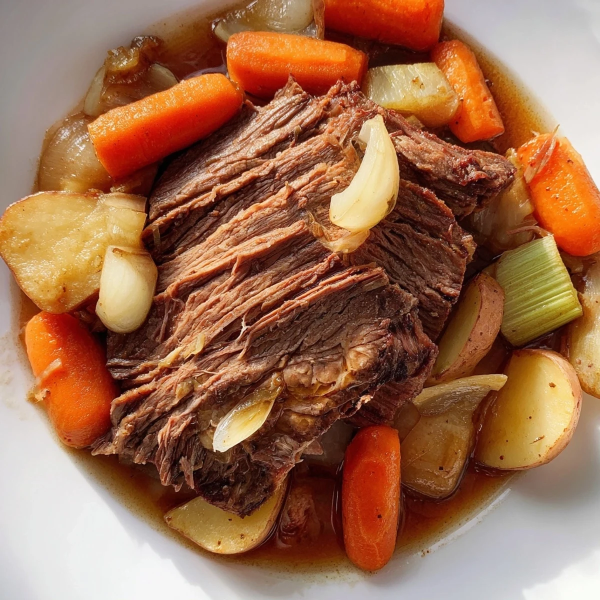 Savory beef pot roast surrounded by caramelized onions, carrots, and parsnips on a rustic wooden table.