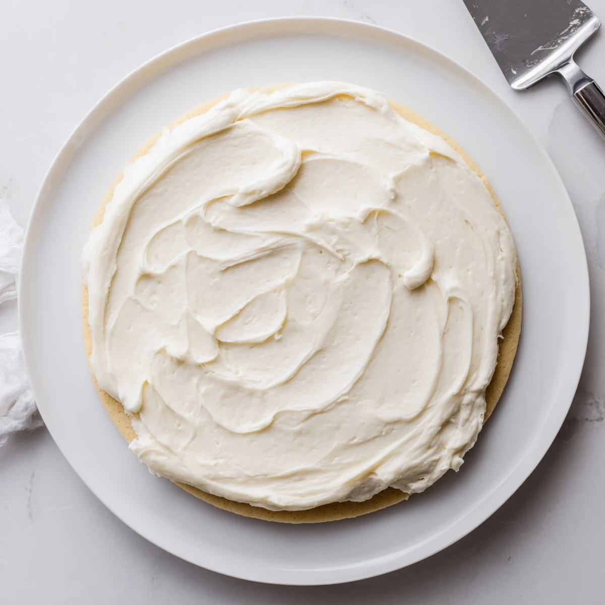 Light and fluffy vanilla Easy Sugar Cookie Frosting with a slight crust, perfect for topping cupcakes and treats.