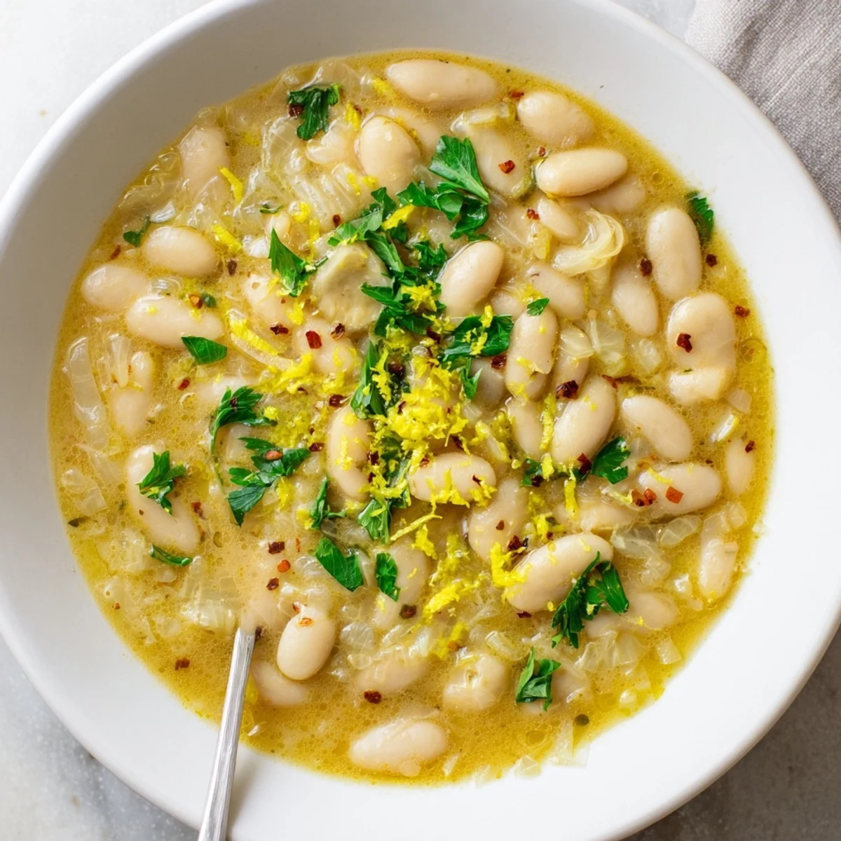 Comforting Miso Butter Brothy Beans simmered with aromatics, ready to be enjoyed as a vegetarian main.