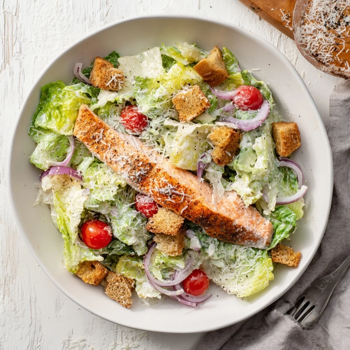 Succulent grilled salmon Caesar salad featuring crunchy romaine, golden croutons, and tangy dressing for dinner