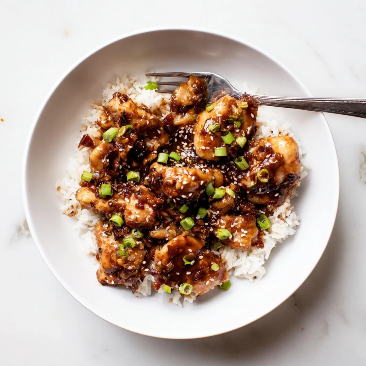 Slow cooker Huli Huli chicken glazed with sticky pineapple soy sauce and sesame seeds