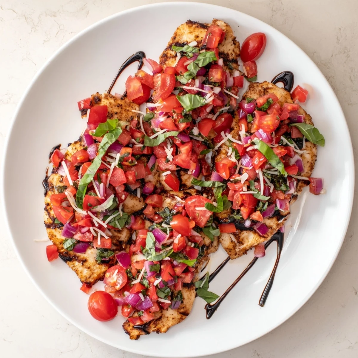 Golden pan-seared Bruschetta Chicken topped with fresh diced tomatoes and melted mozzarella cheese