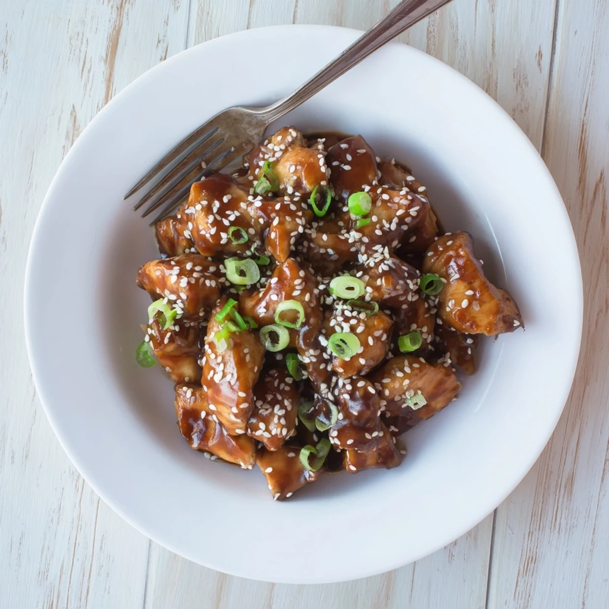 Shredded Crock Pot Sesame Chicken served over fluffy white rice with toasted sesame seed topping