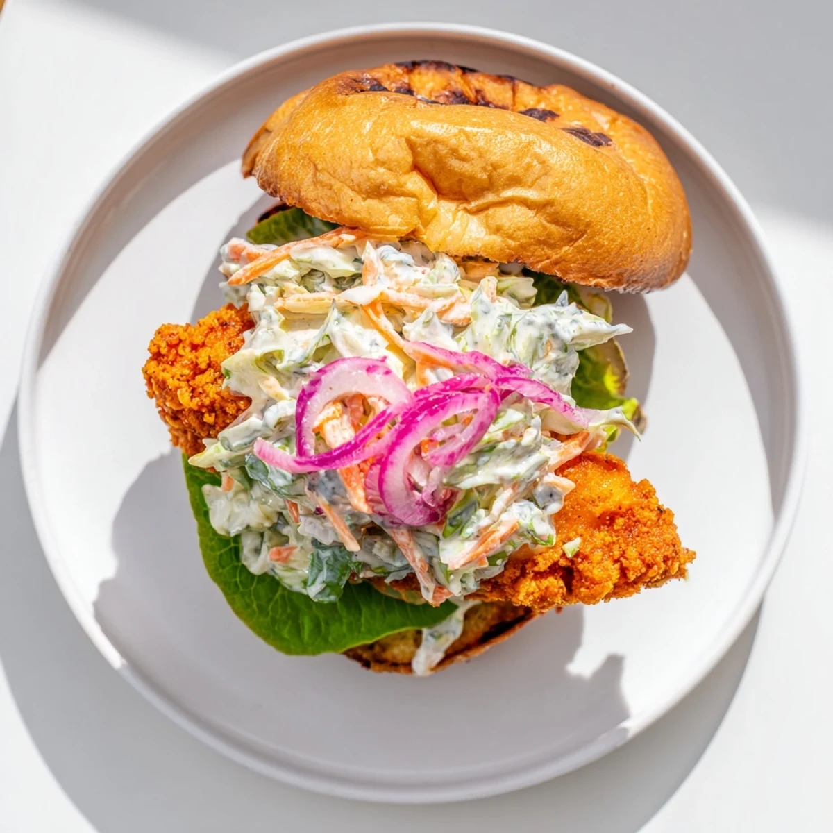 Spicy crispy buffalo chicken sandwich layered with tangy ranch coleslaw on golden toasted brioche