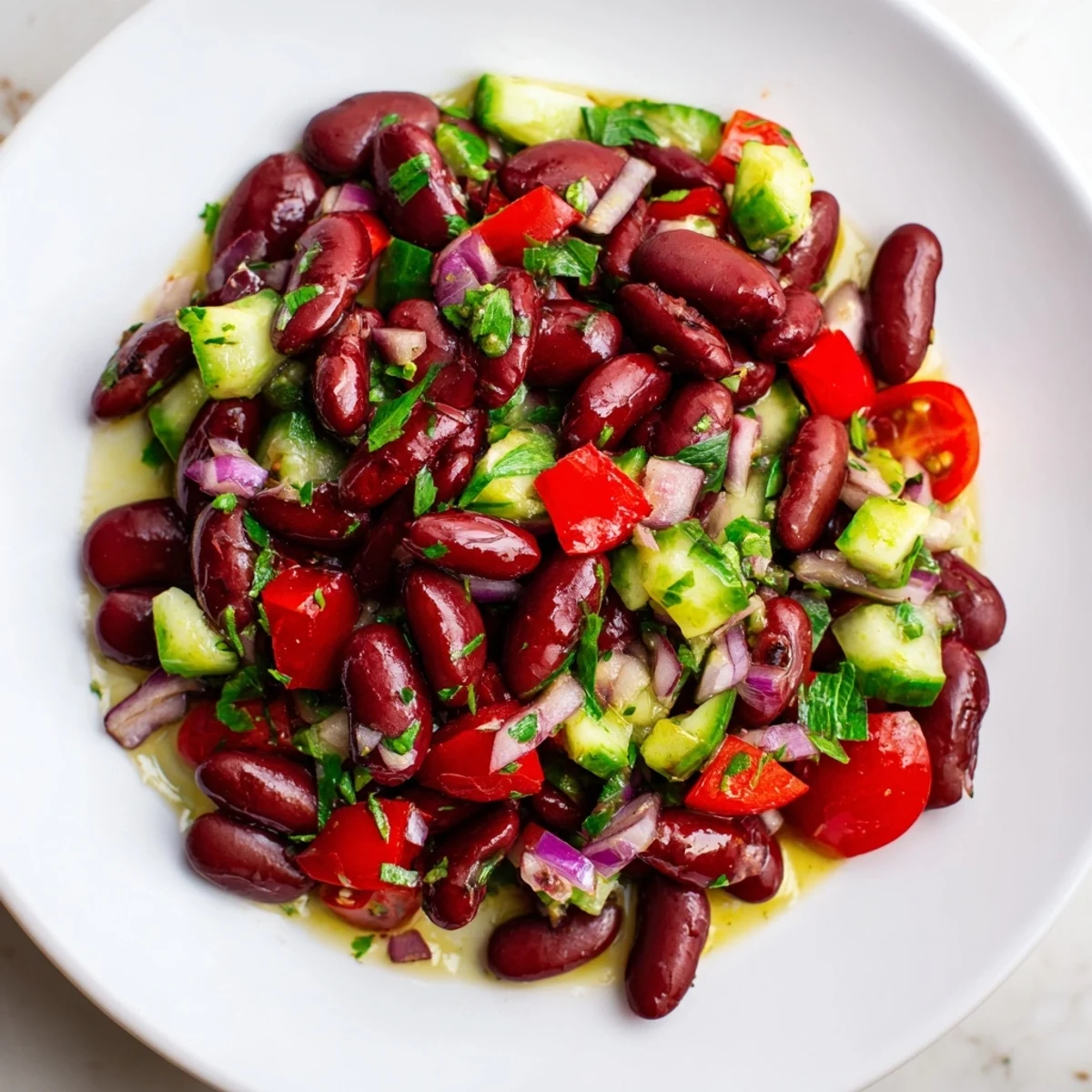 Colorful kidney bean salad tossed with crisp bell pepper and tangy vinaigrette in a rustic bowl
