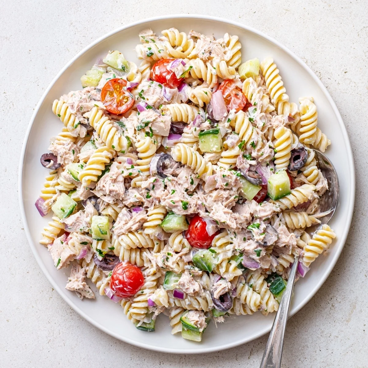 Chilled tuna pasta salad with colorful veggies and tender fusilli coated in tangy dressing
