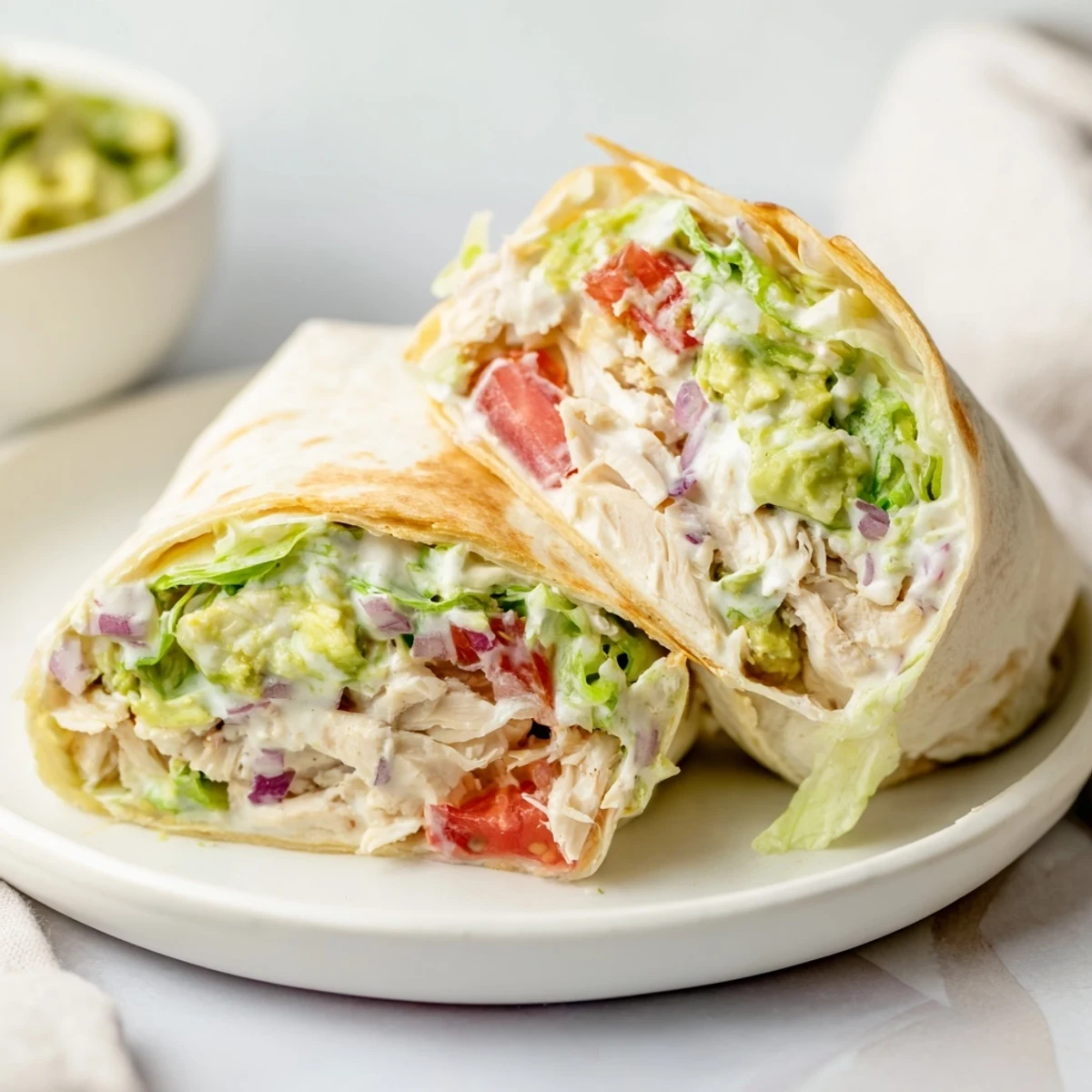 Chicken Avocado Ranch Burritos cut in half, golden toast and creamy filling