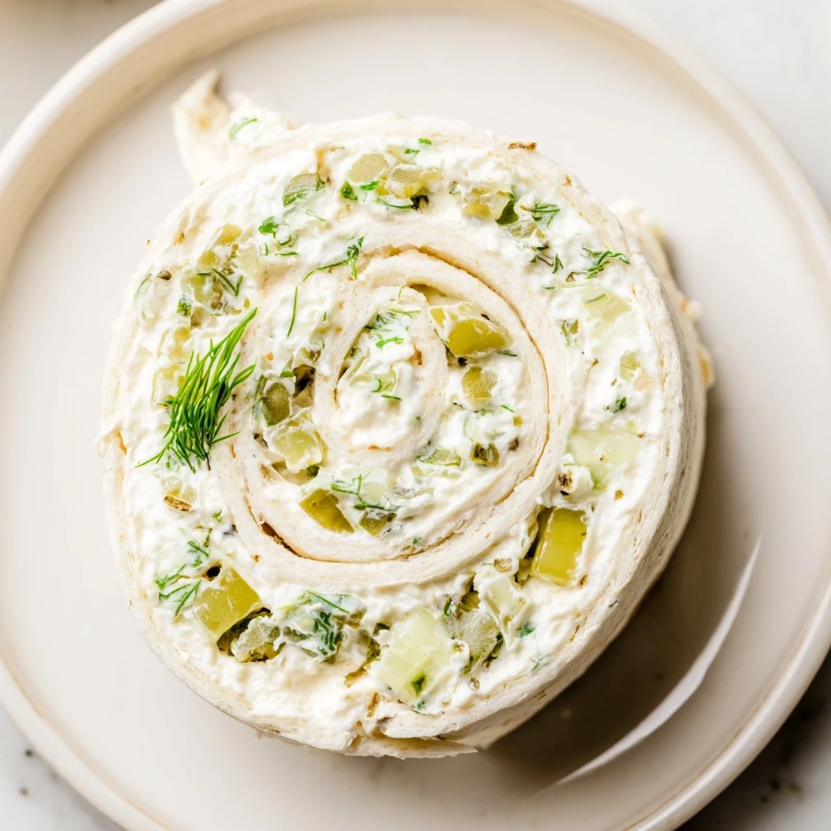 Creamy Pickle Dip Pinwheels sliced neatly, soft tortillas and fresh dill