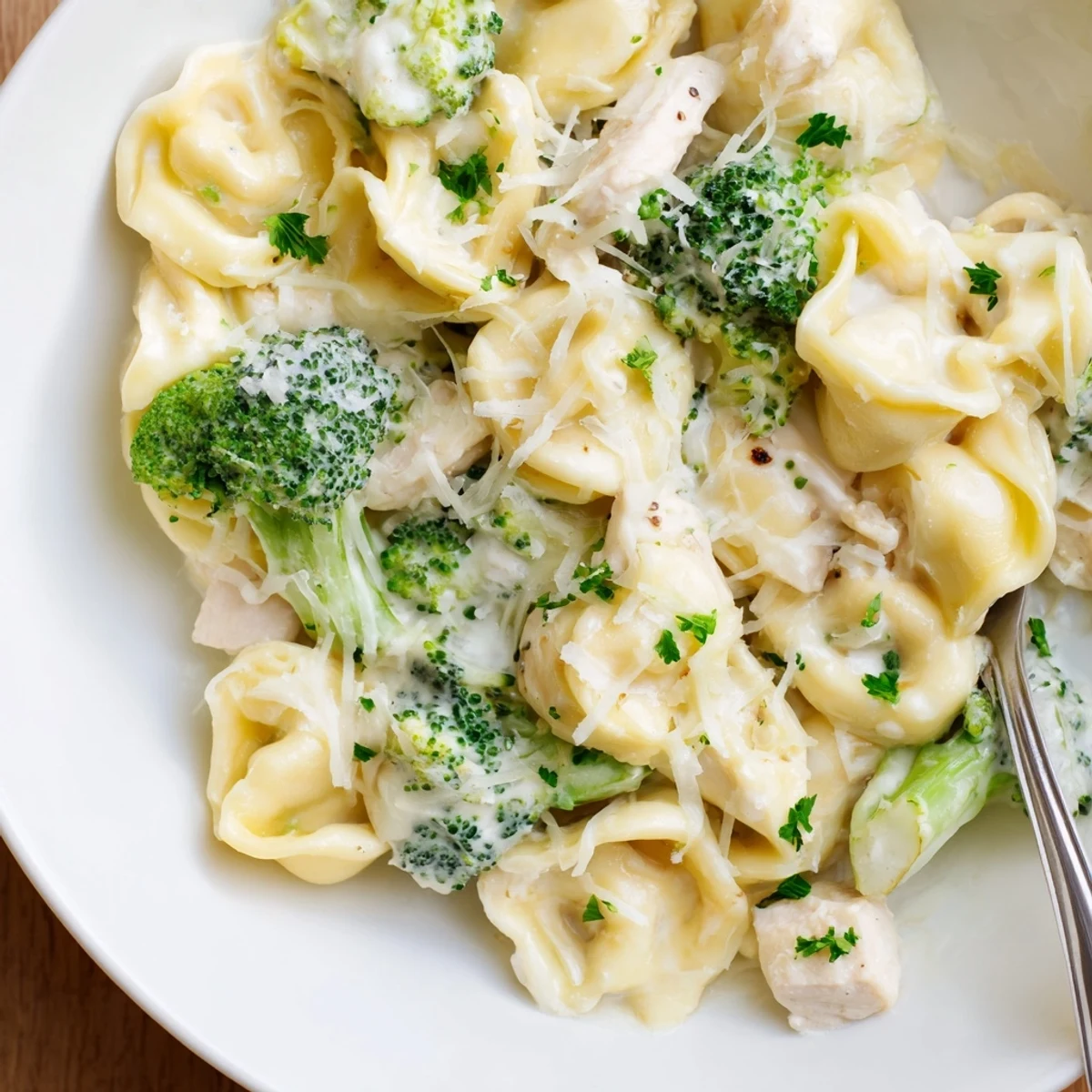 Creamy Garlic Parmesan Tortellini Chicken Broccoli Recipe with golden sear and rising steam