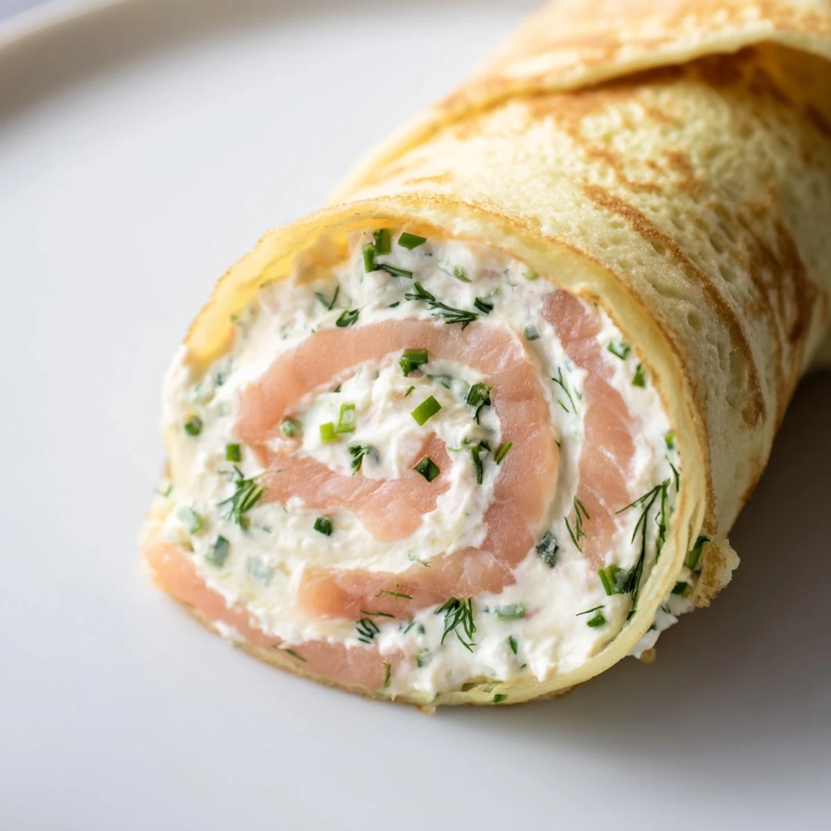 Delicate French crepes wrapped around silky smoked salmon and tangy cream cheese filling topped with chopped chives