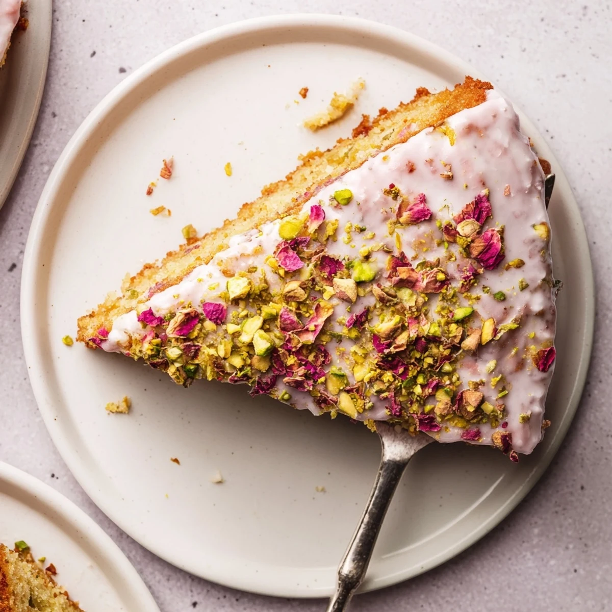 Golden Persian Love Cake with rosewater icing drizzle and crushed pistachios on top