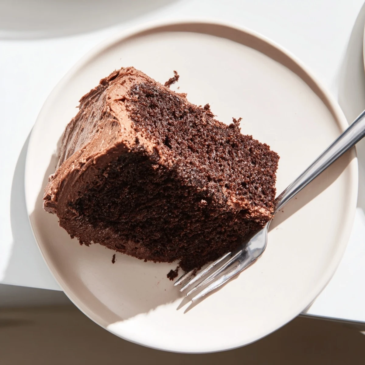 Rich chocolate mayonnaise cake with fudgy texture topped with chocolate frosting swirls