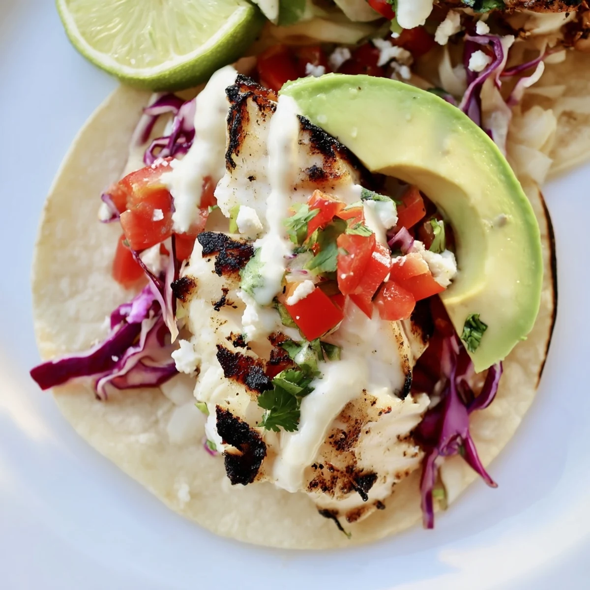 Light and zesty grilled fish tacos featuring perfectly charred white fish, crisp cabbage slaw, and aromatic fresh cilantro garnish.
