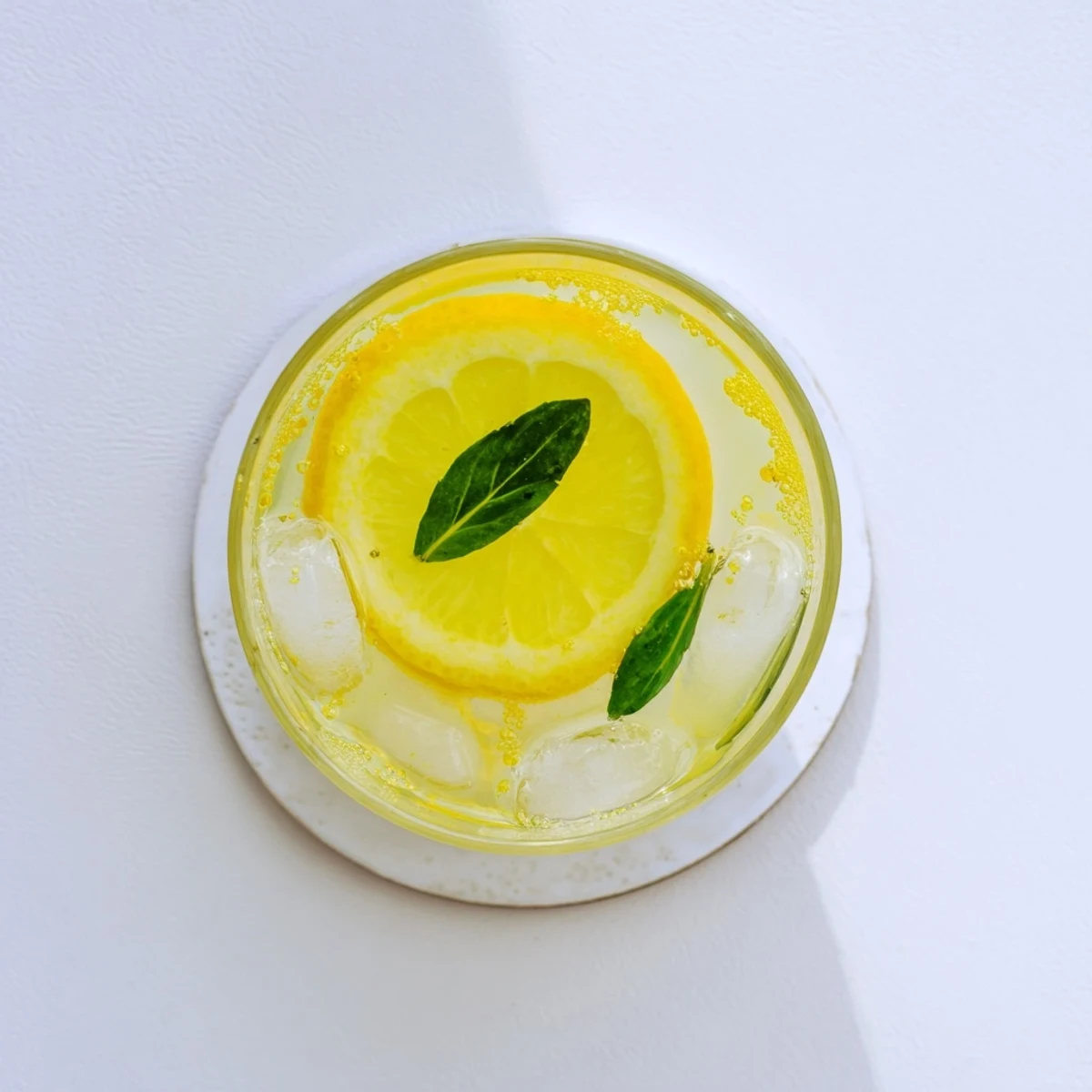 Cool pitcher of fresh squeezed lemonade served over ice with citrus wheel garnish