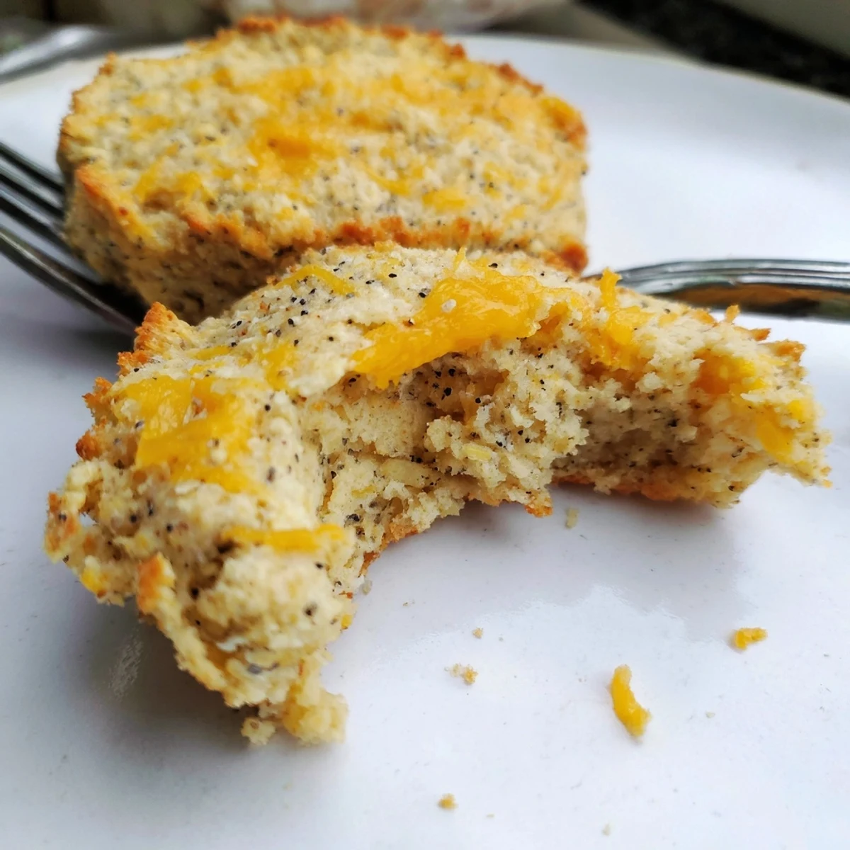 Golden brown high protein breakfast biscuits fresh from the oven with cheddar cheese melted on top