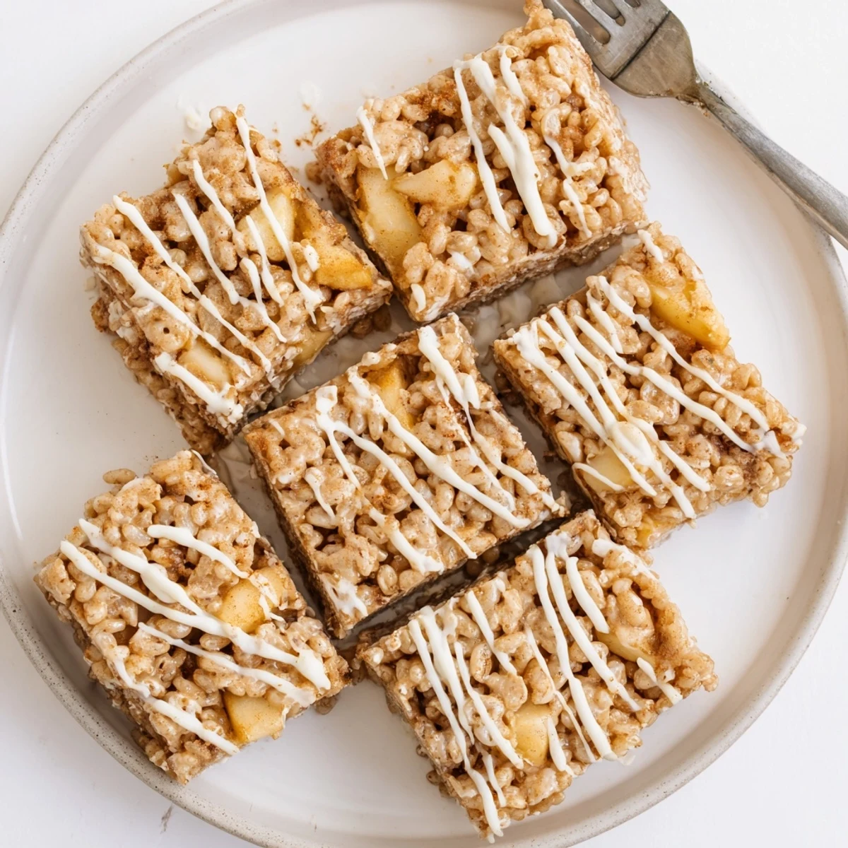 Festive Apple Pie Rice Krispie Treats squares with gooey caramelized apple pieces throughout