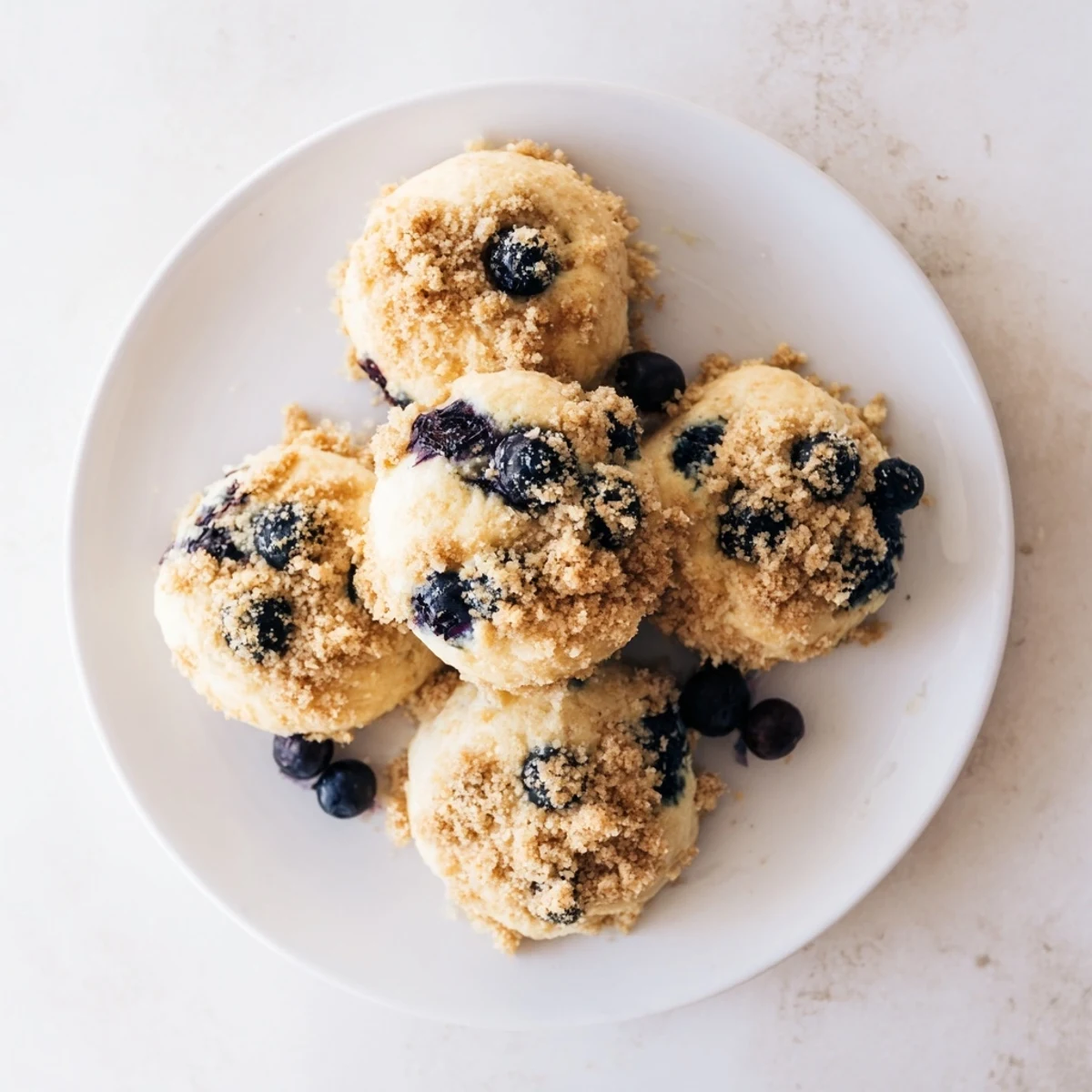 Golden blueberry muffin cookies bursting with juicy berries and crumbly streusel topping