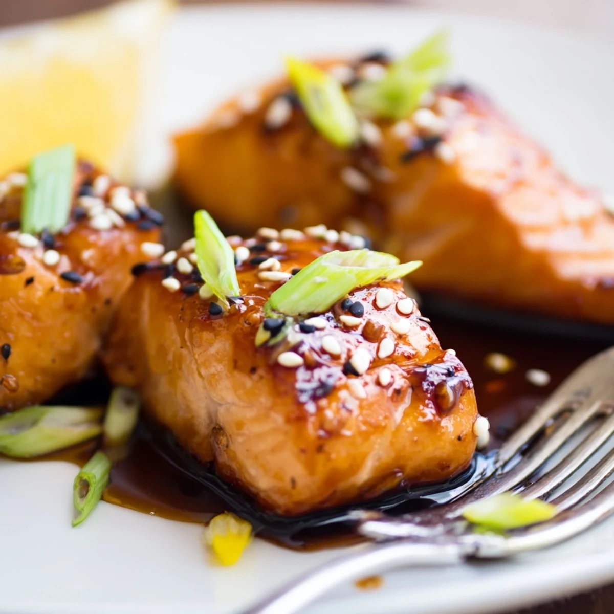 Honey Glazed Salmon Bites caramelized and glossy cubes on a lemon garnished platter