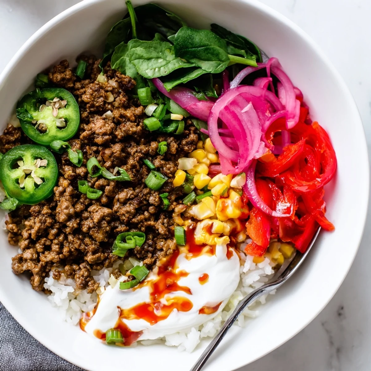 Viral Ground Beef Hot Honey Bowl served over fluffy rice with pickled jalapeños