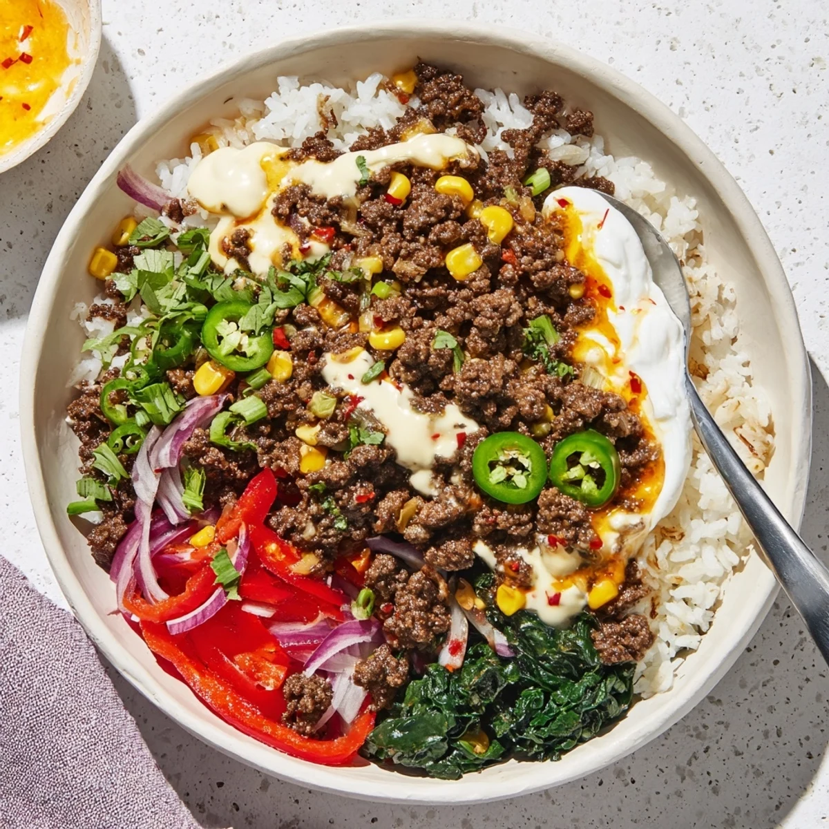 Steaming Viral Ground Beef Hot Honey Bowl topped with charred peppers and cilantro