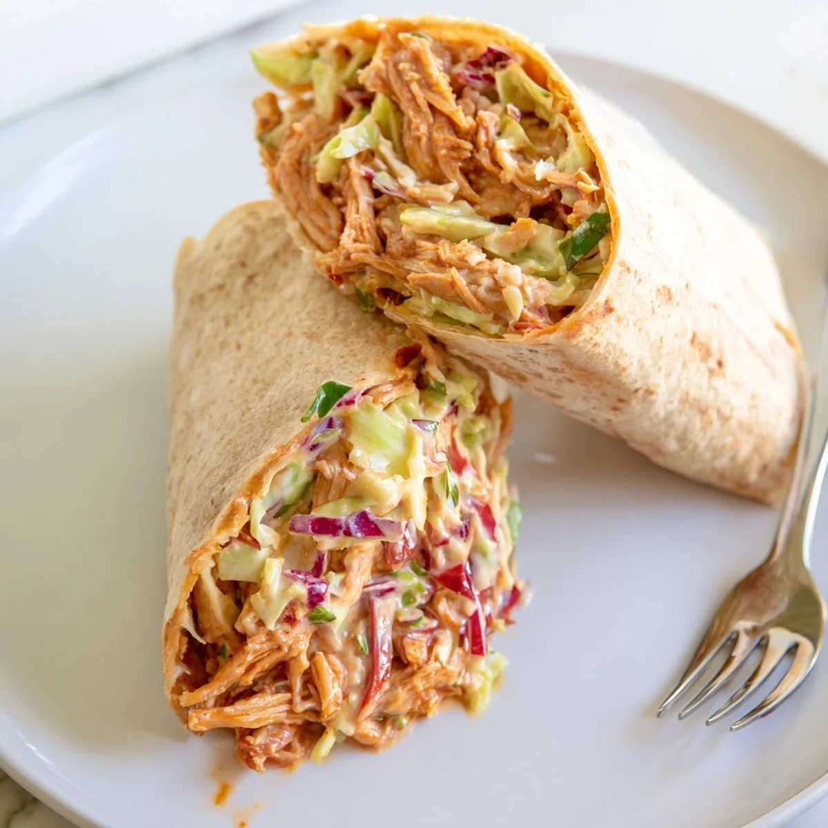 Crisp BBQ Chicken Coleslaw Wraps on a plate, ready for picnic enjoyment.
