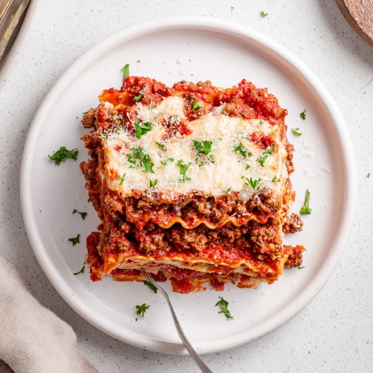 Warm Slow Cooker Lasagna layered with ricotta, herbs, and golden baked cheese