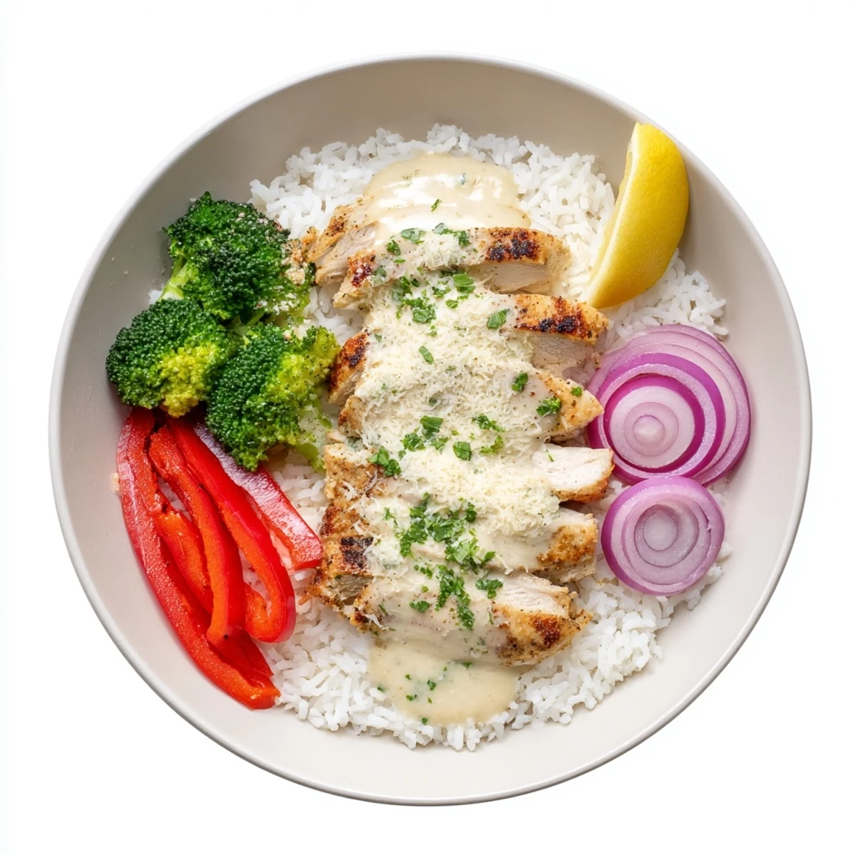 Grilled Chicken Broccoli Bowls with Creamy Garlic Sauce finished with lemon wedge and parsley