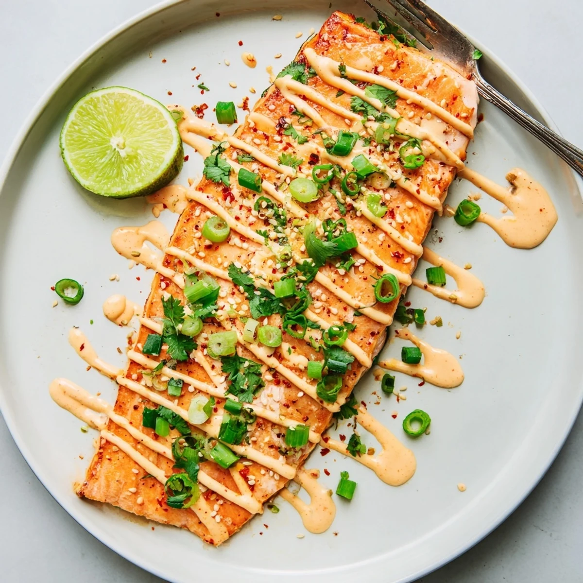 Bang Bang Salmon atop jasmine rice, topped with sesame seeds and scallions