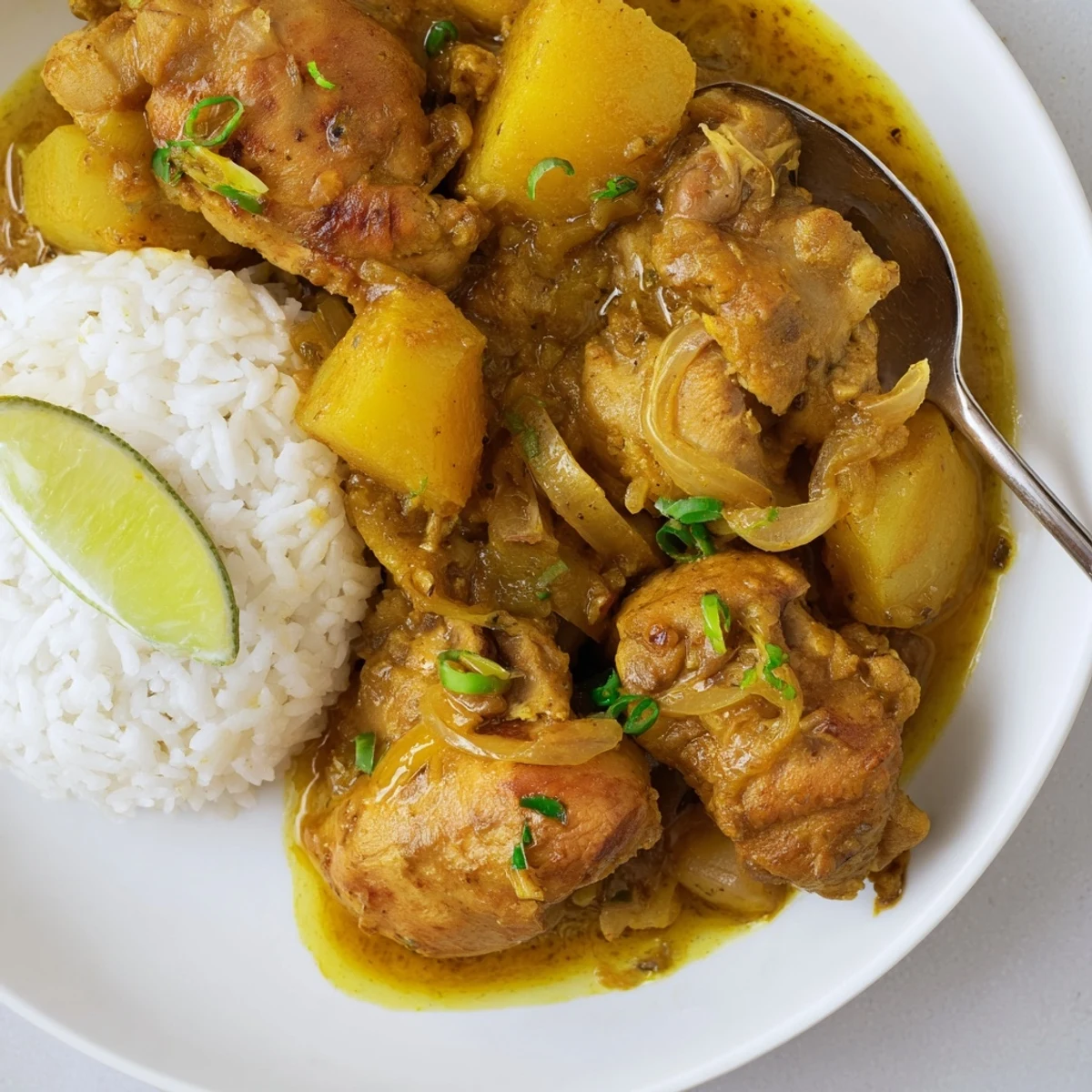 Fork-tender Irresistibly Tender Jamaican Curry Chicken with creamy coconut broth and potatoes.