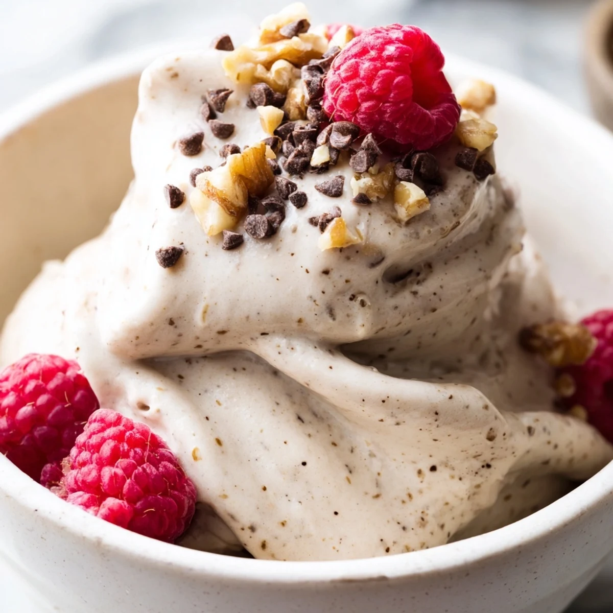 Smooth banana nice cream recipe served in glass bowls with ripe banana slices