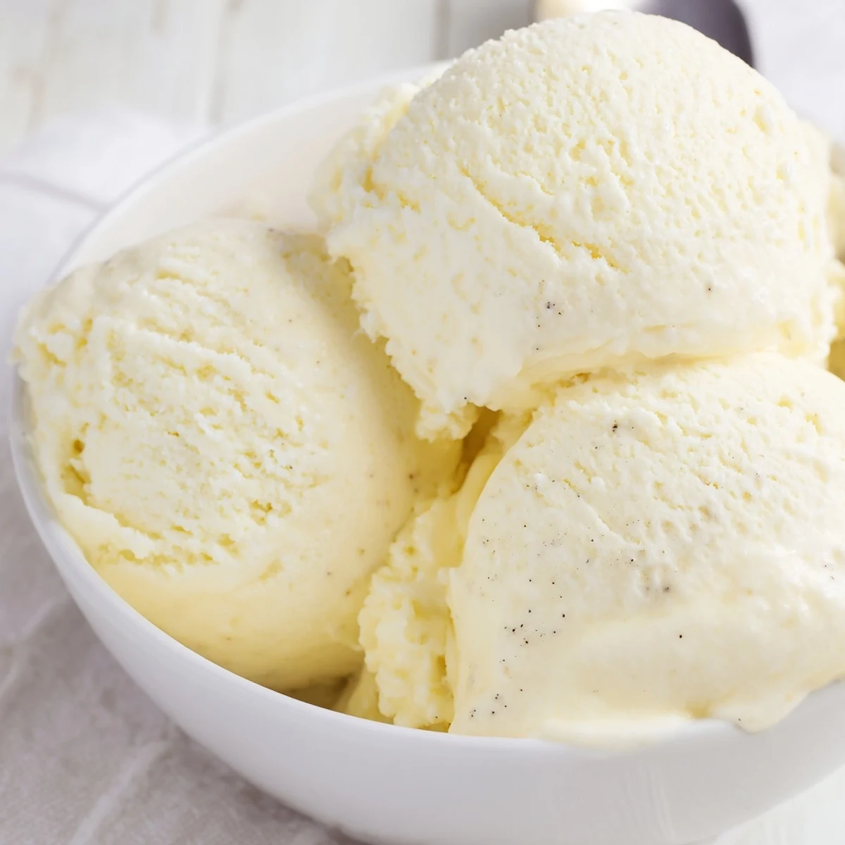 Creamy vanilla ice cream served in a classic dessert bowl with sprinkles on top