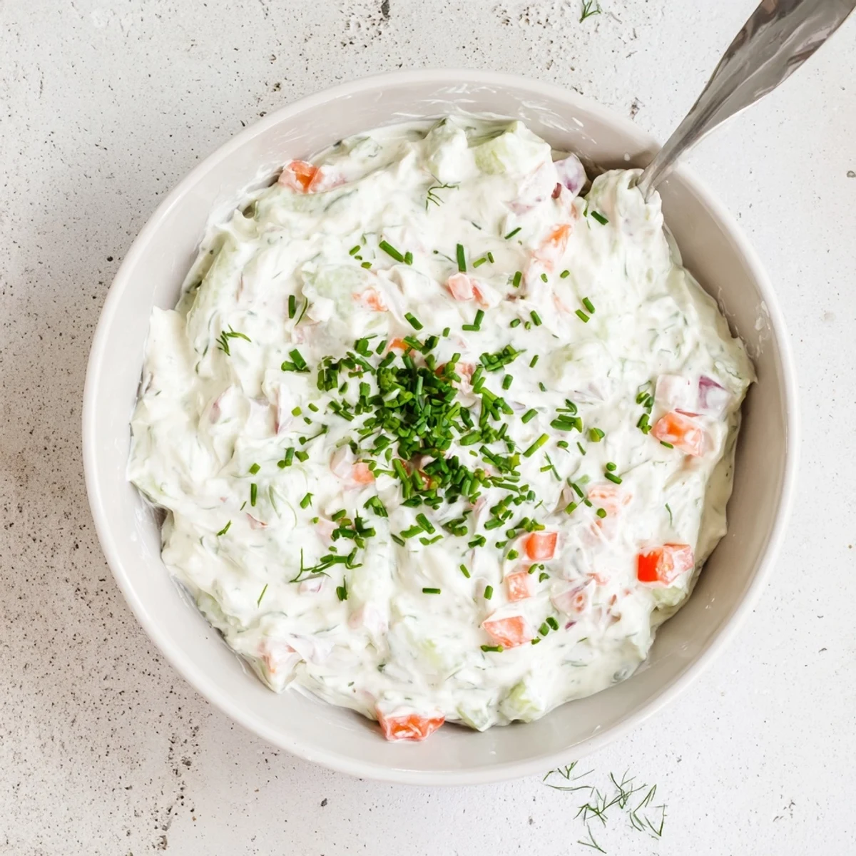 Creamy Grillos Pickle De Gallo Ranch Dip served in white bowl surrounded by colorful vegetable chips and fresh crunchy celery sticks