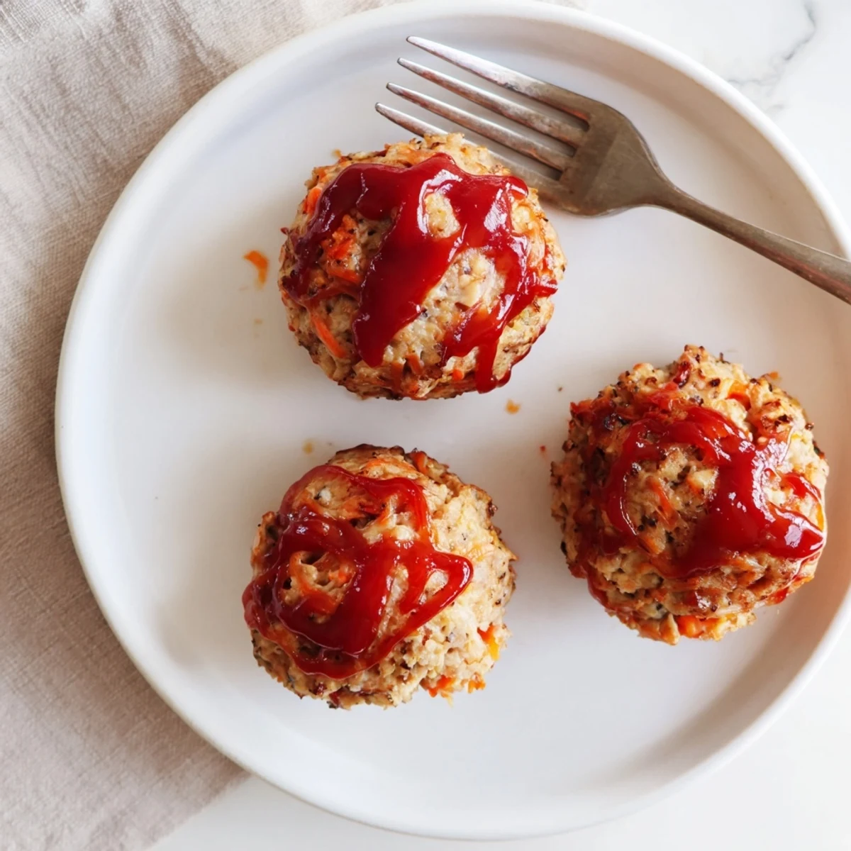Mini meatloaves made with lean ground turkey, oats, and colorful vegetables in individual muffin portions