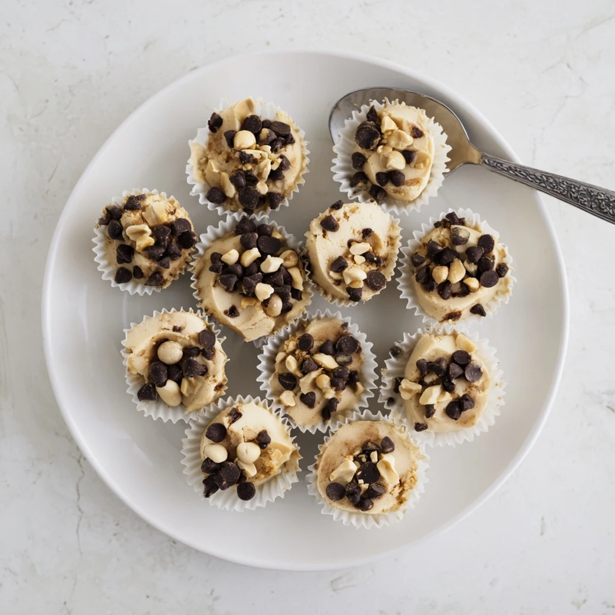 Creamy high protein frozen peanut butter Greek yogurt bites arranged in a mini muffin tin