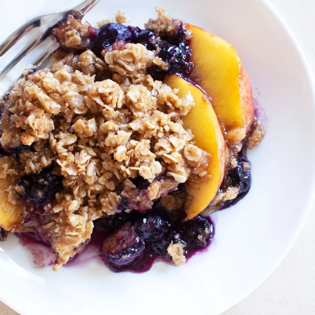 Rustic Blueberry Peach Crumble fresh from oven, juicy fruit and cinnamon aroma