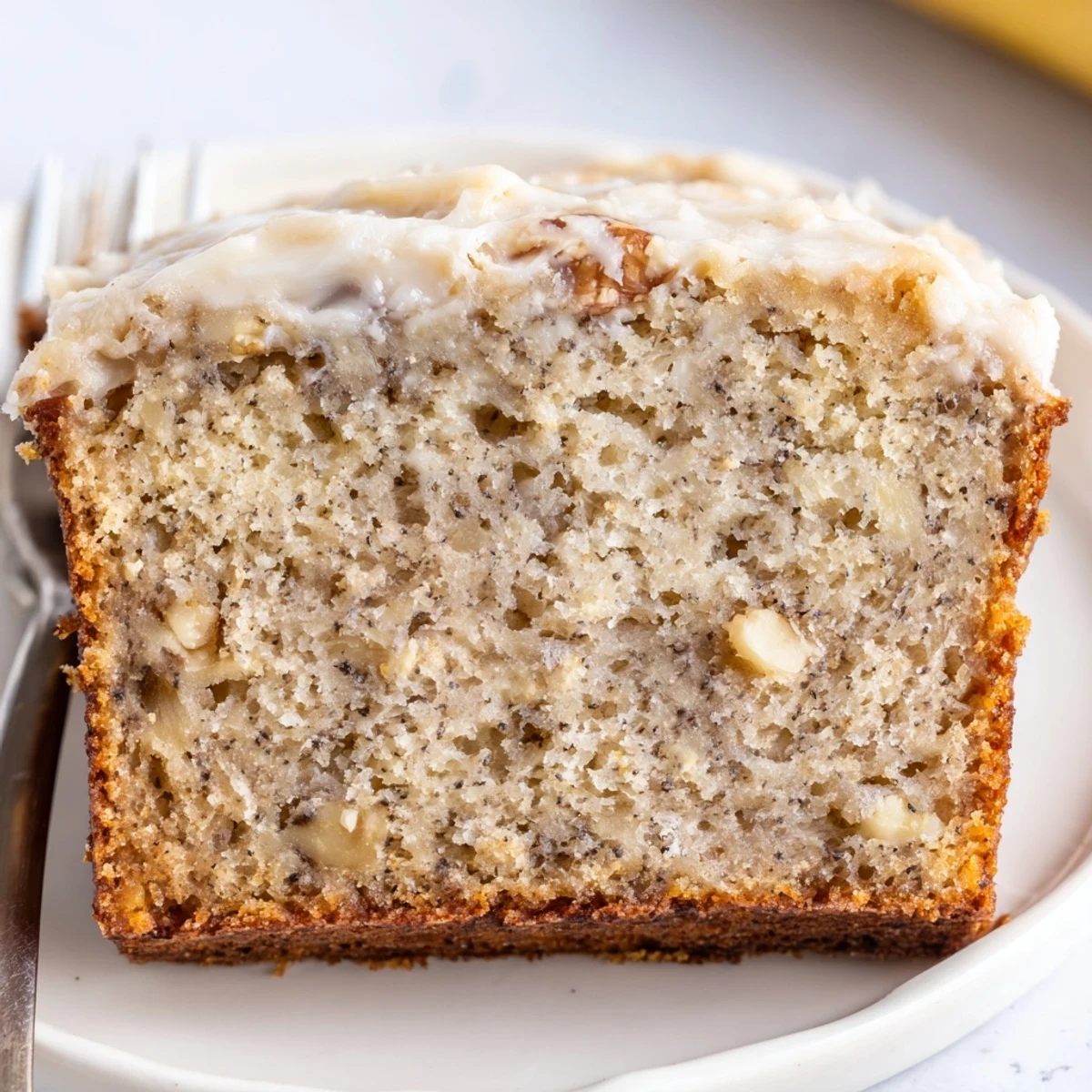 Moist Banana Cake with golden crumb, sliced beside coffee for brunch.