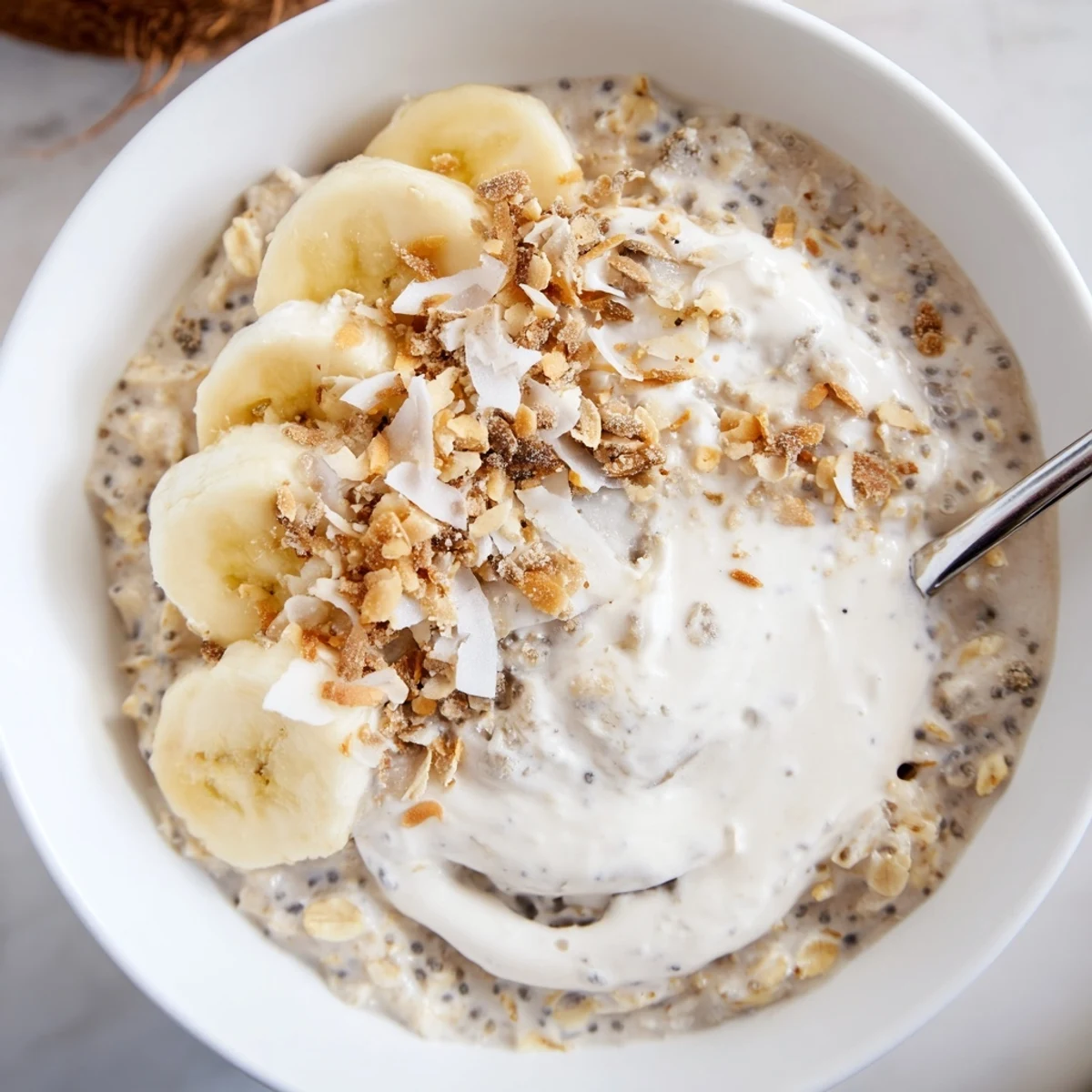 A jar of Coconut Cream Pie Overnight Oats, creamy coconut milk and chia