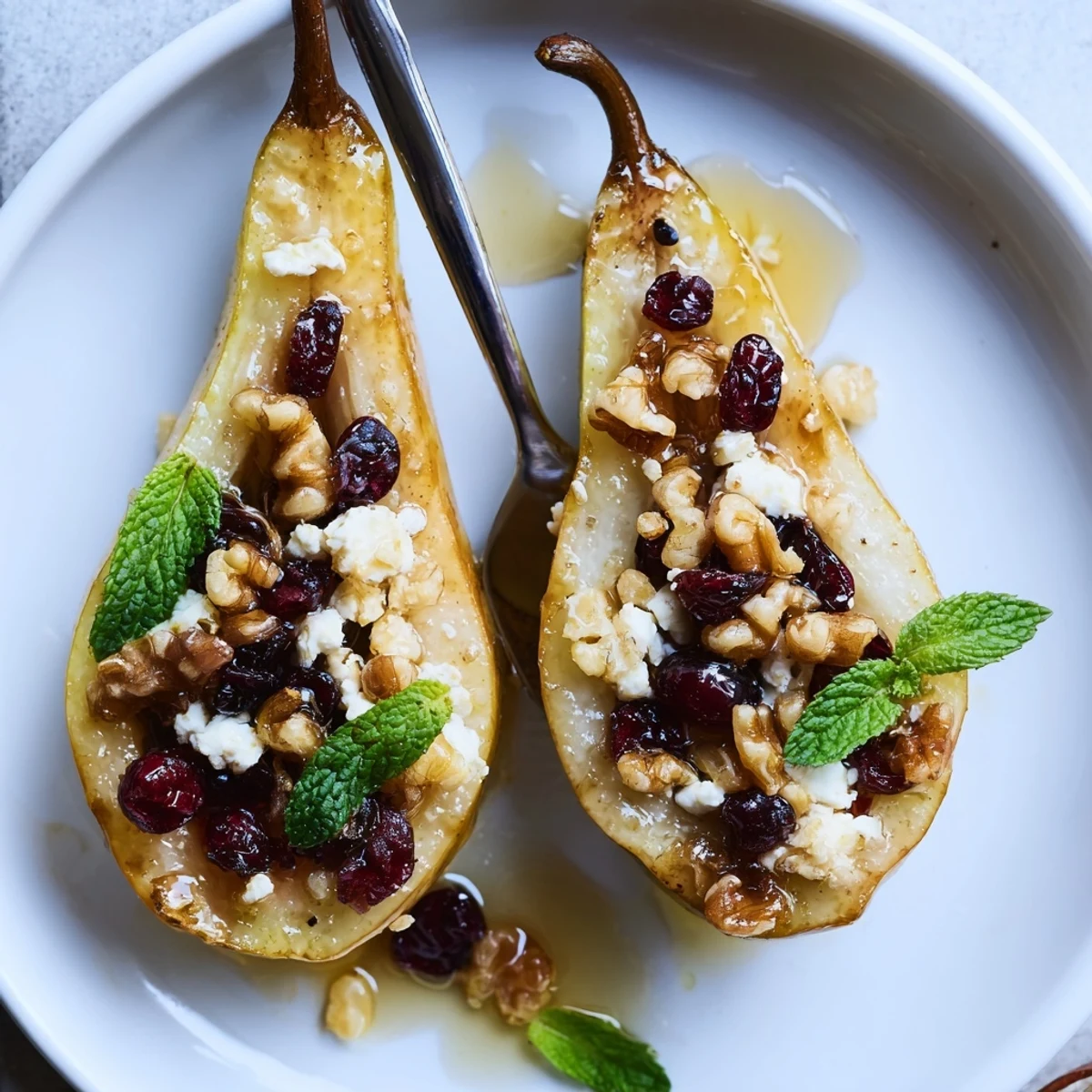 Baked Pears With Feta Honey Cranberries, glossy caramelized edges, warm honey drizzle, mint