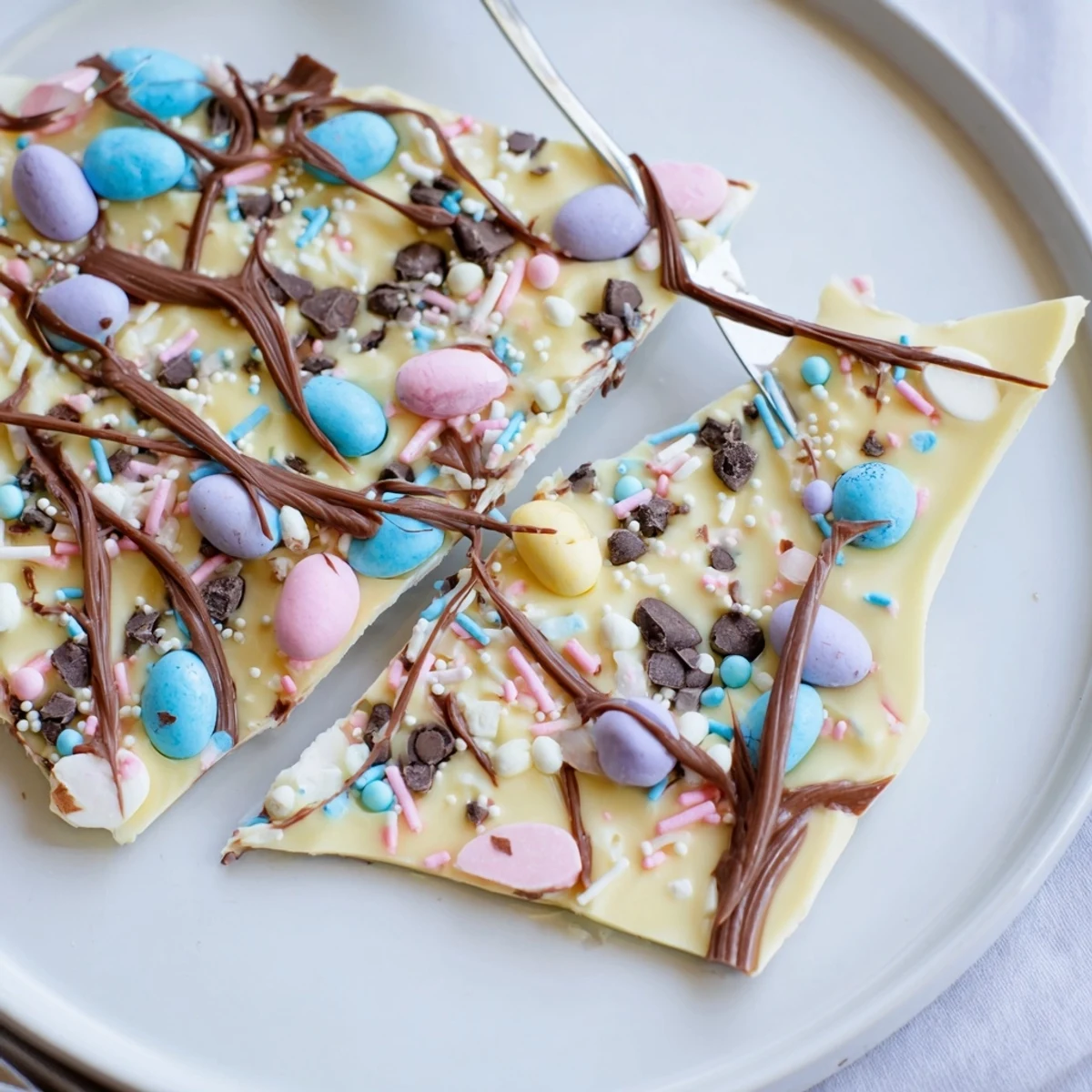 Robin Egg Easter Bark on parchment, glossy swirls and crunchy candy eggs.
