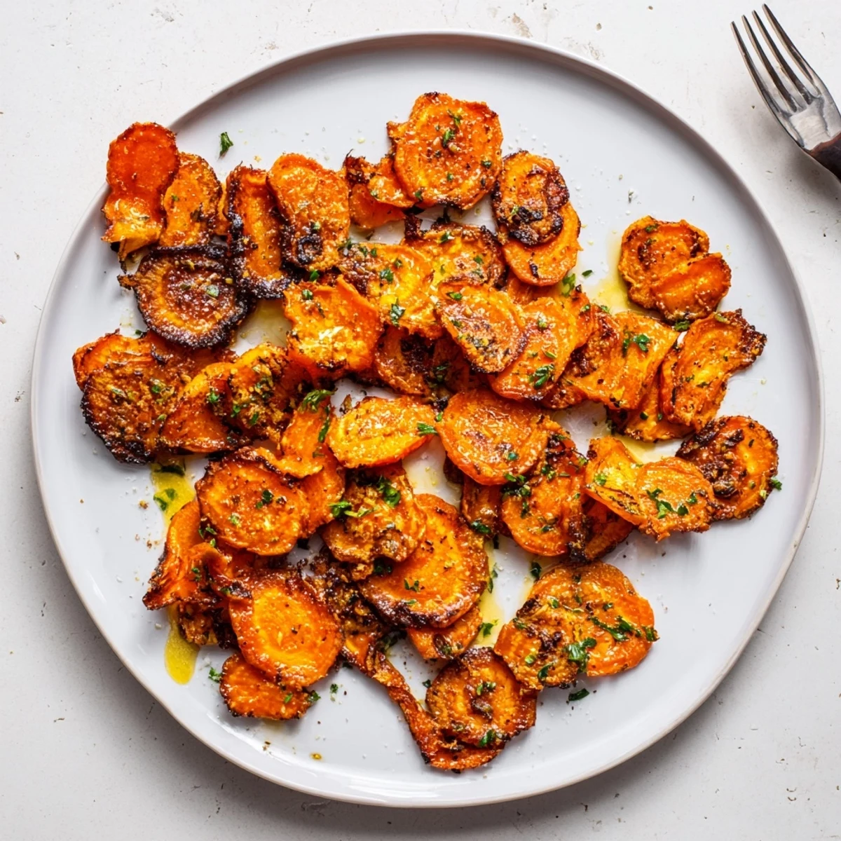 Crispy Smashed Carrots roasted to golden brown with parsley and lemon wedge
