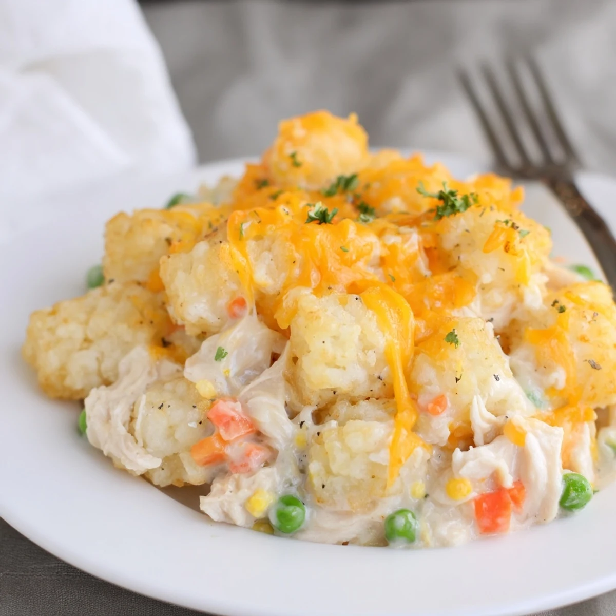 Family-style Cheesy Chicken Tater Tot Bake Delight bubbling, creamy chicken and veggies